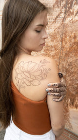 A woman with a jagua henna stain on her back