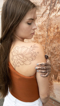 A woman with a jagua henna stain on her back