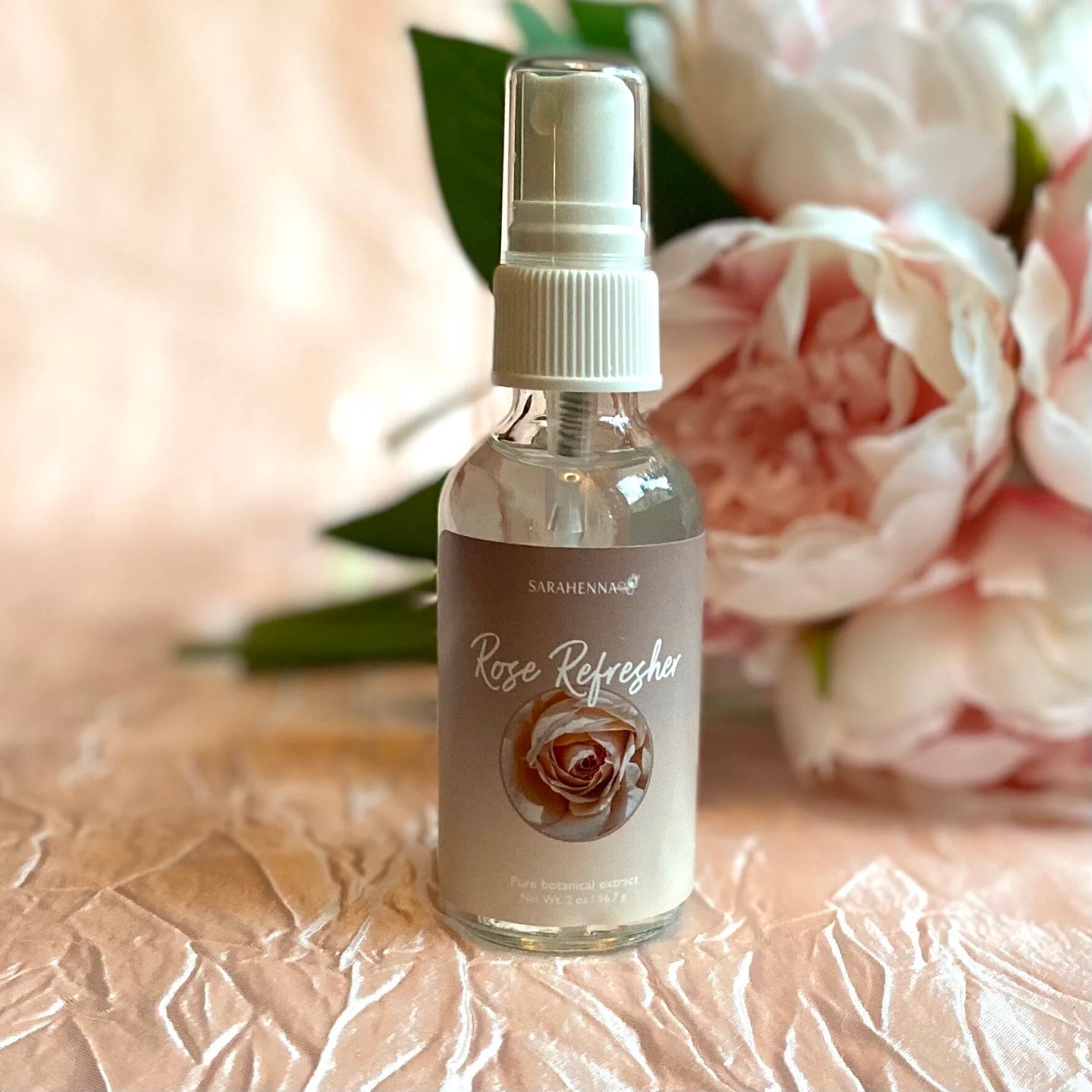 A glass bottle of rose hydrosol spray