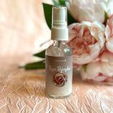 A glass bottle of rose hydrosol spray
