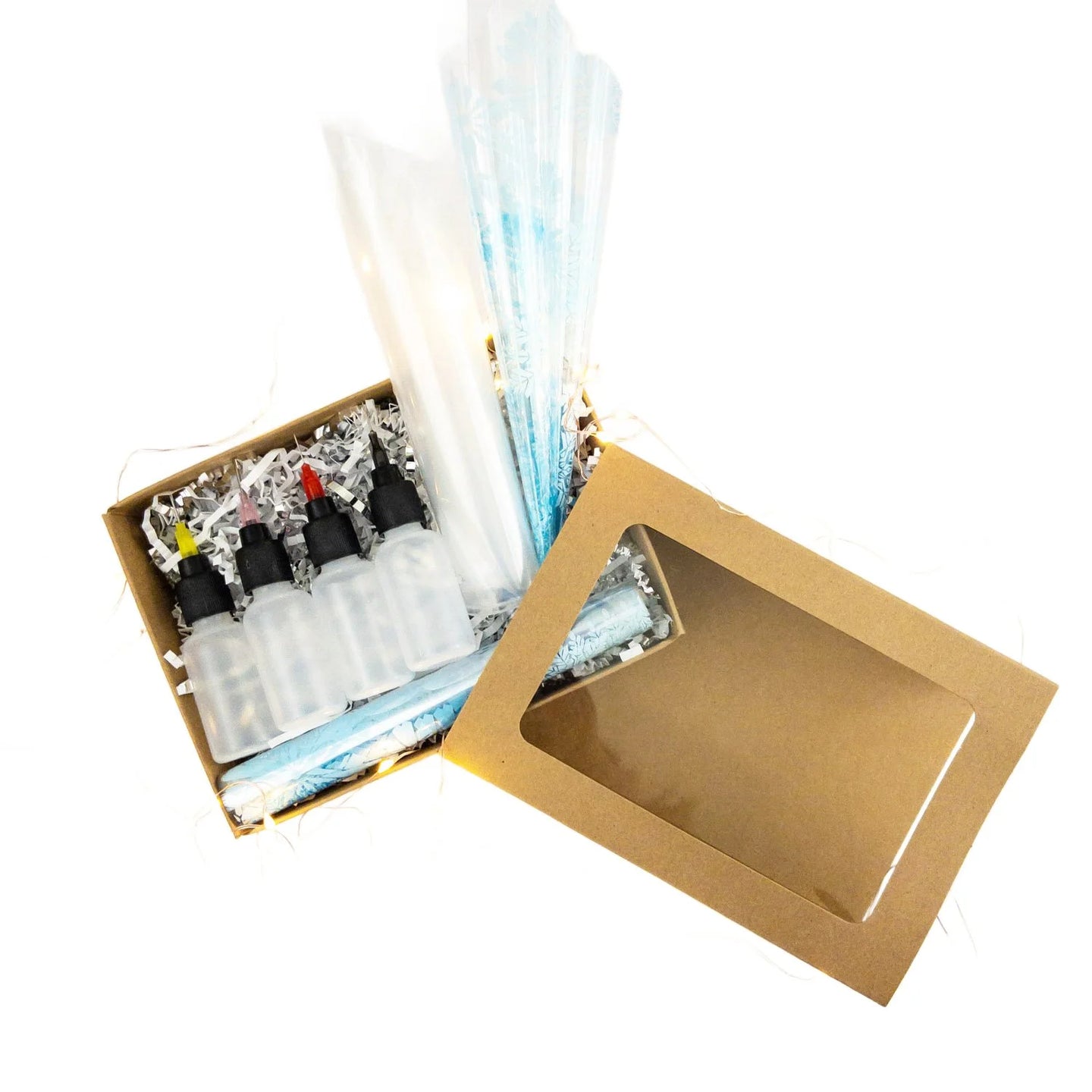 A box containing a variety of different applicators used for applying henna designs