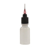 An empty henna applicator bottle