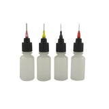 A row of 4 plastic squeeze bottles used for applying henna designs, with 4 different sized tips