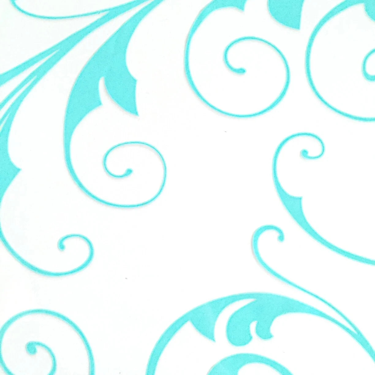 A rectangular sheet of cellophane with a turquoise swirl pattern for making henna cones
