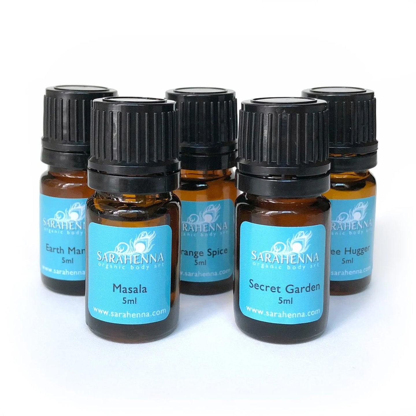 A row of essential oil blends in glass bottles for mixing fresh henna