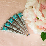 A set of 5 handmade henna cones next to pink roses