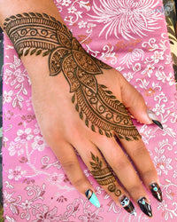 A beautiful lotus theme henna design on a hand