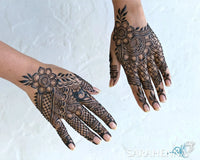 Intricate henna designs on hands