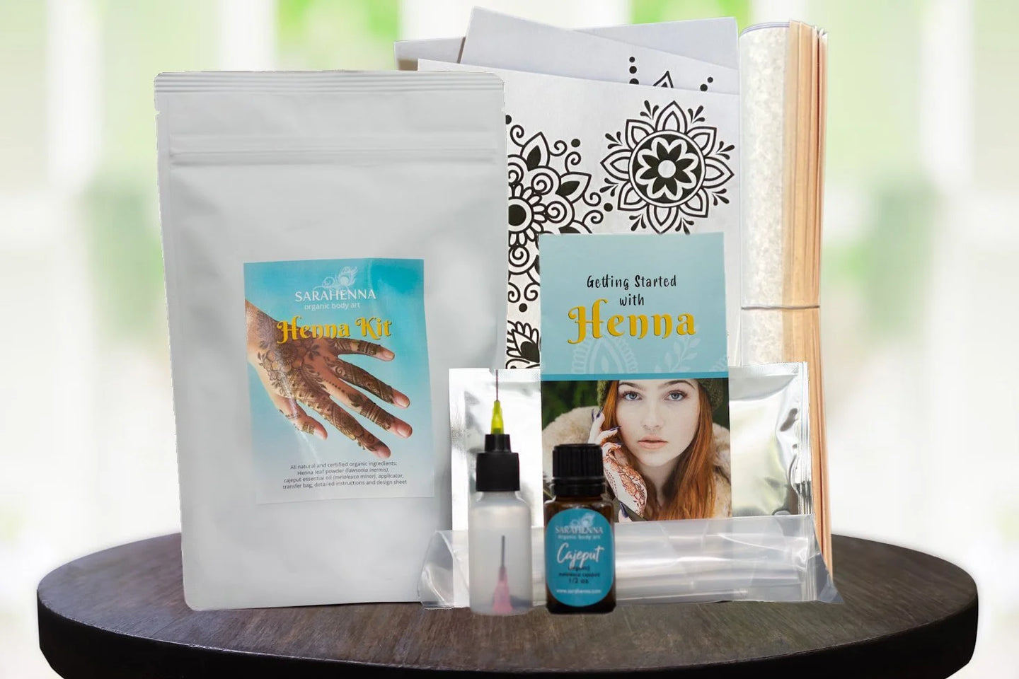 The contents of a henna kit including organic henna powder, essential oil and cute stencils