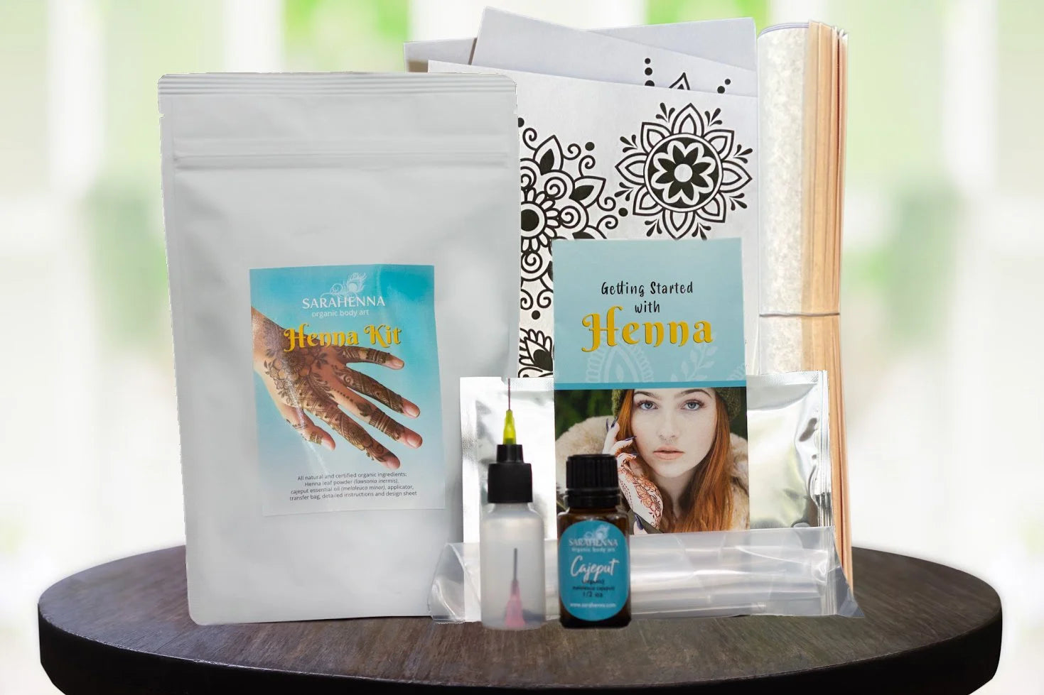 The contents of a henna kit including organic henna powder, essential oil and cute stencils