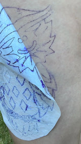 Stencil paper being applied to skin