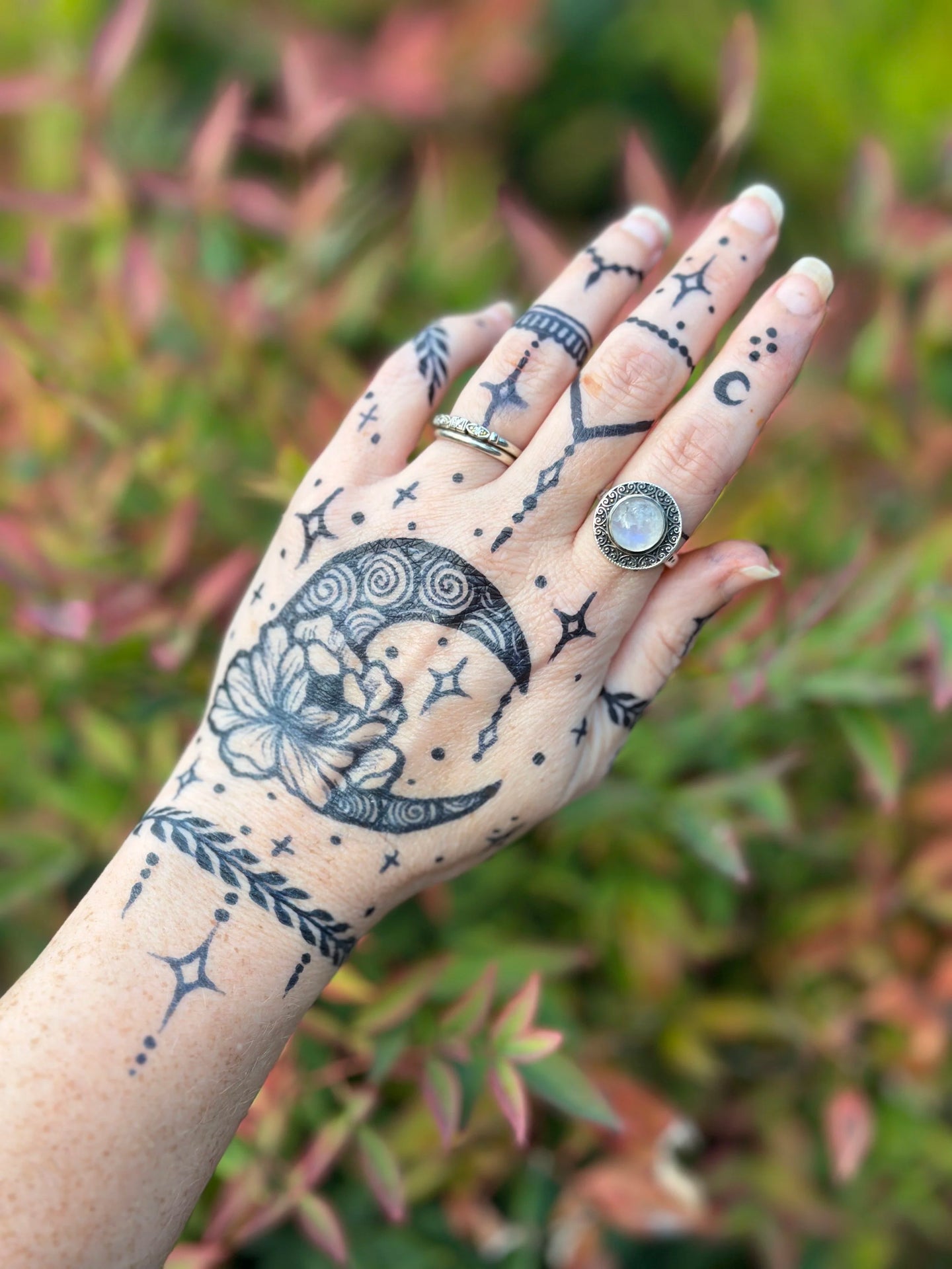 A celestial moon henna design done with jagua