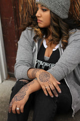 A dark jagua stain on a Black woman's hands