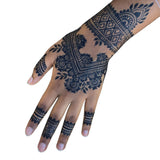 A Black woman's hand with a dark jagua stain