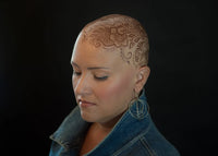 A beautiful henna stain on the head of a woman going through chemotherapy