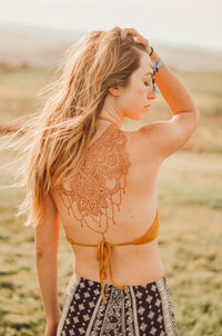 An intricate beautiful henna design on a woman's back