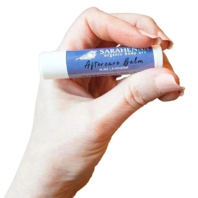 Hand holding a henna aftercare balm