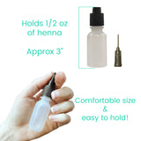 Small bottle for henna with a fine tip held in a hand, labeled with capacity and size information.