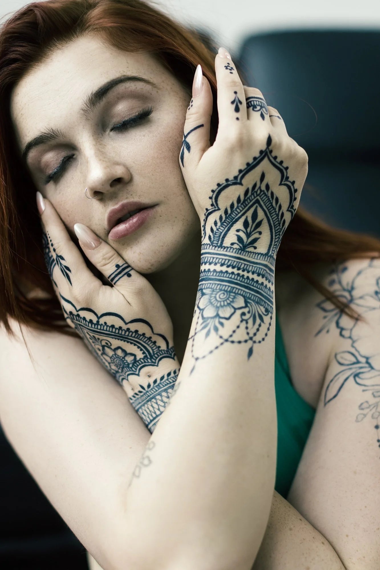An ultra dark blue black jagua design on a woman's hands