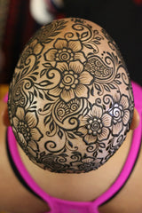 An intricate floral henna crown
